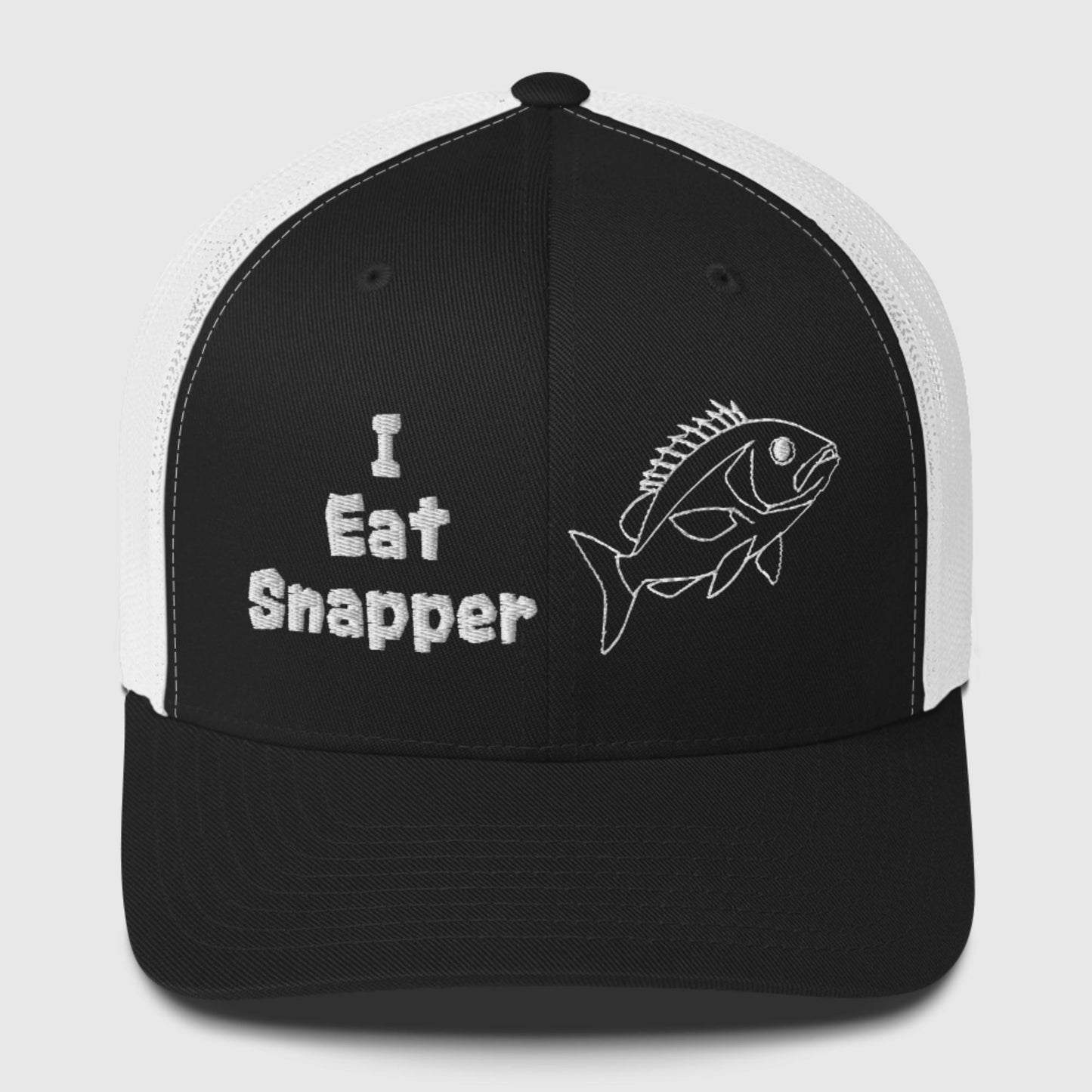 White mesh black front panel trucker cap with white “I Eat Snapper” text and fish embroidery, front view