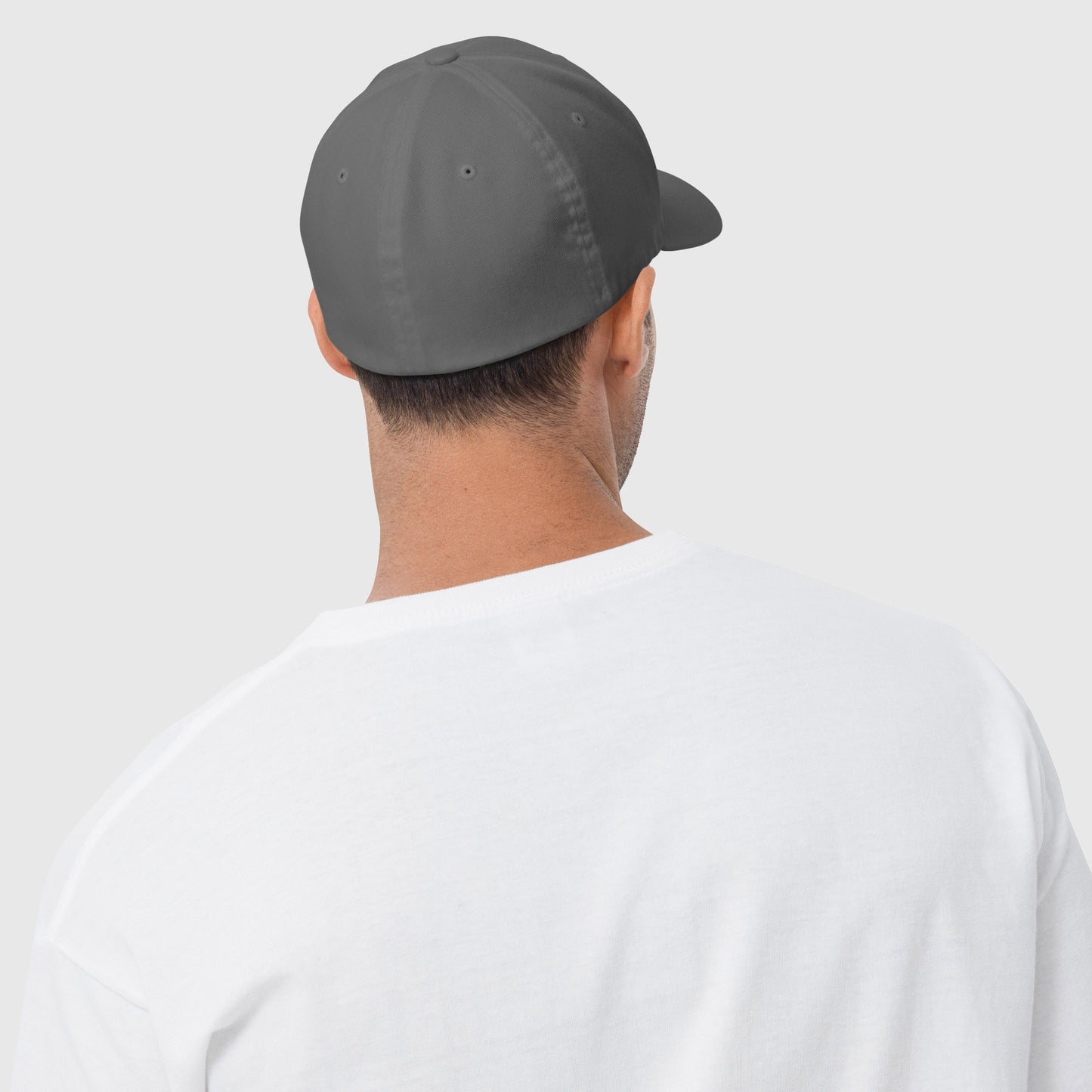 man in white shirt wearing grey can't catch em on the couch closed back dad hat