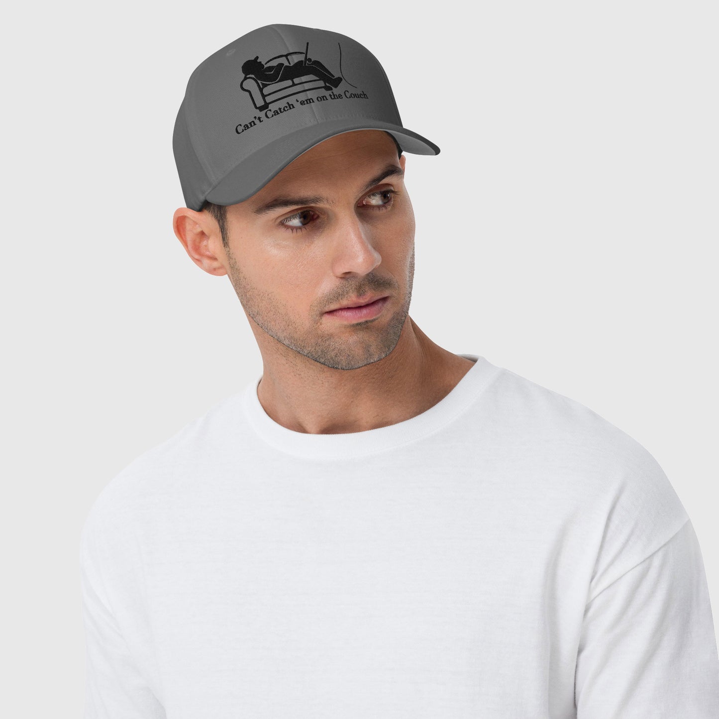 Man in white shirt wearing dark grey dad hat with couch fishing design