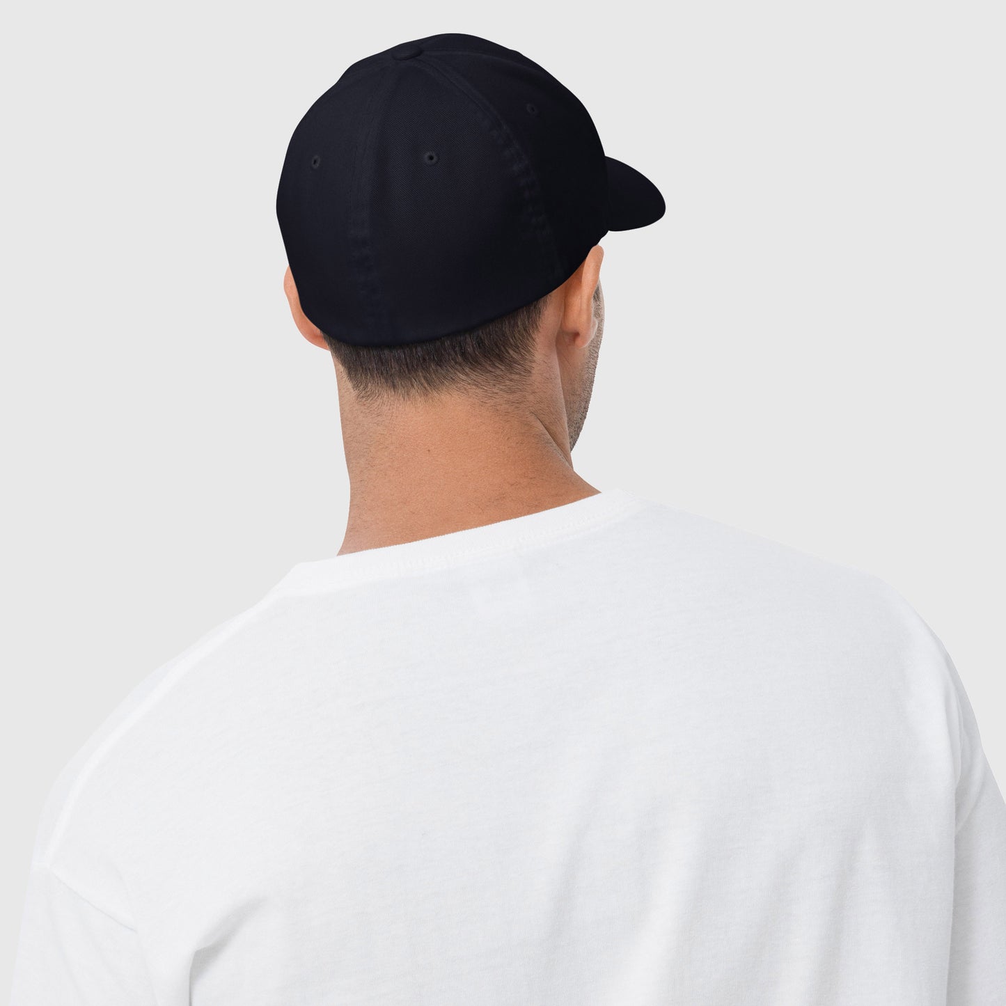 Man wearing navy closed back dad hat backwards