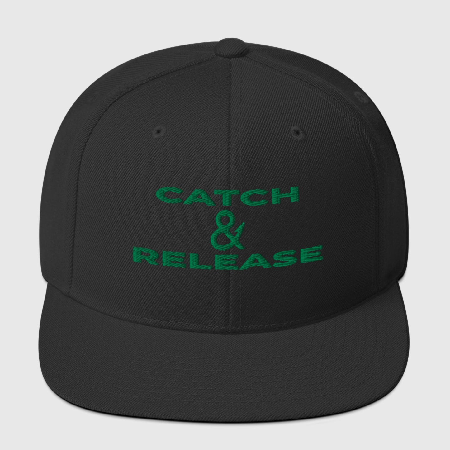 Black snapback with green "Catch & Release" text, front view