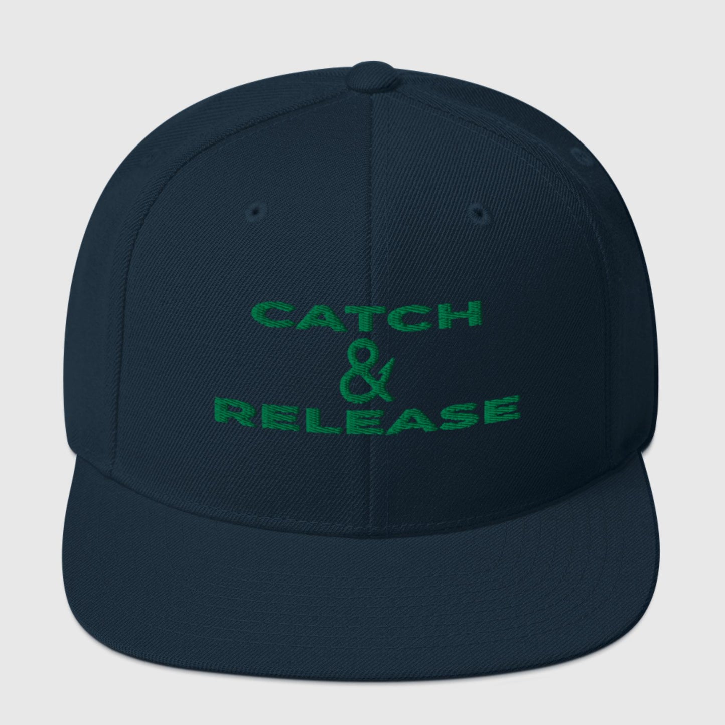 Navy snapback hat featuring green "Catch & Release" lettering