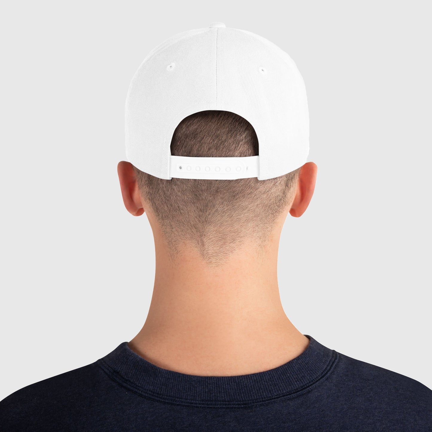 Back view of white snapback hat with green catch and release text