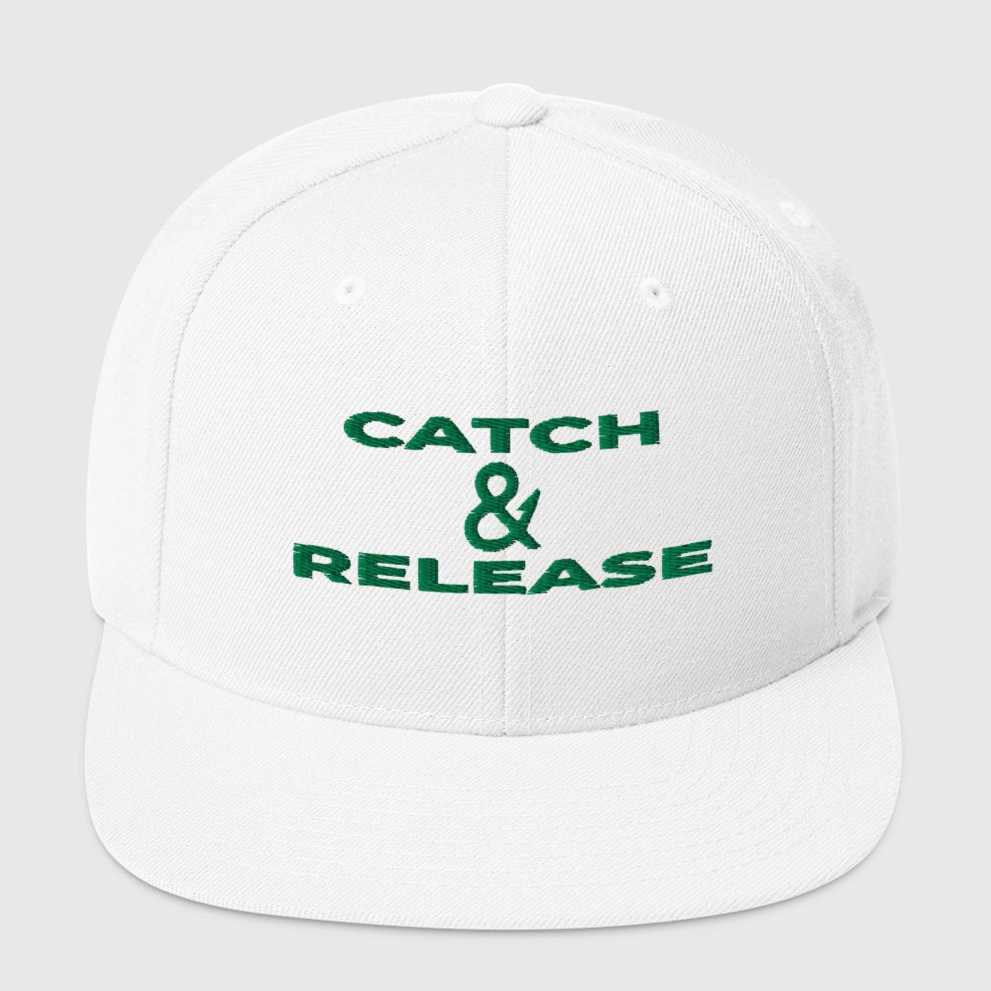 White snapback hat with green "Catch & Release" text, front view