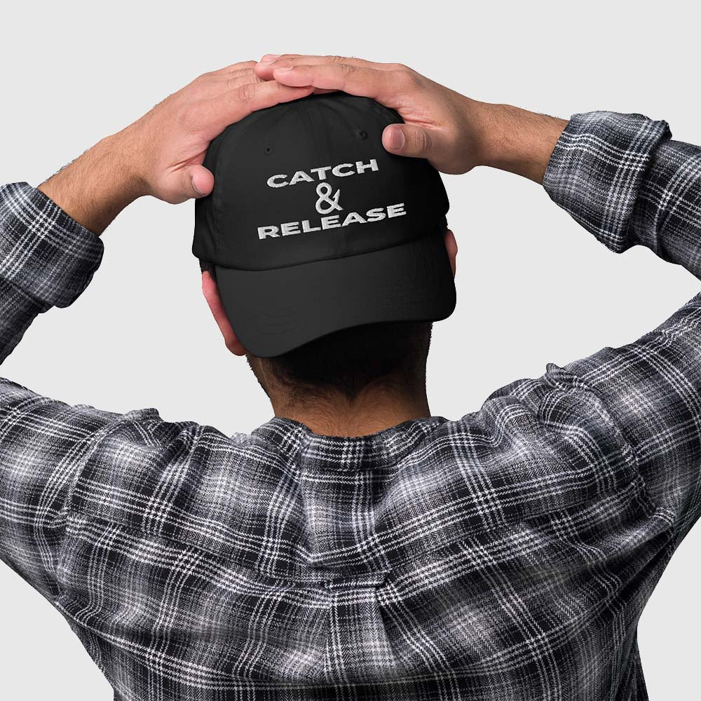 Person shown from behind wearing Catch & Release dad hat turned backwards
