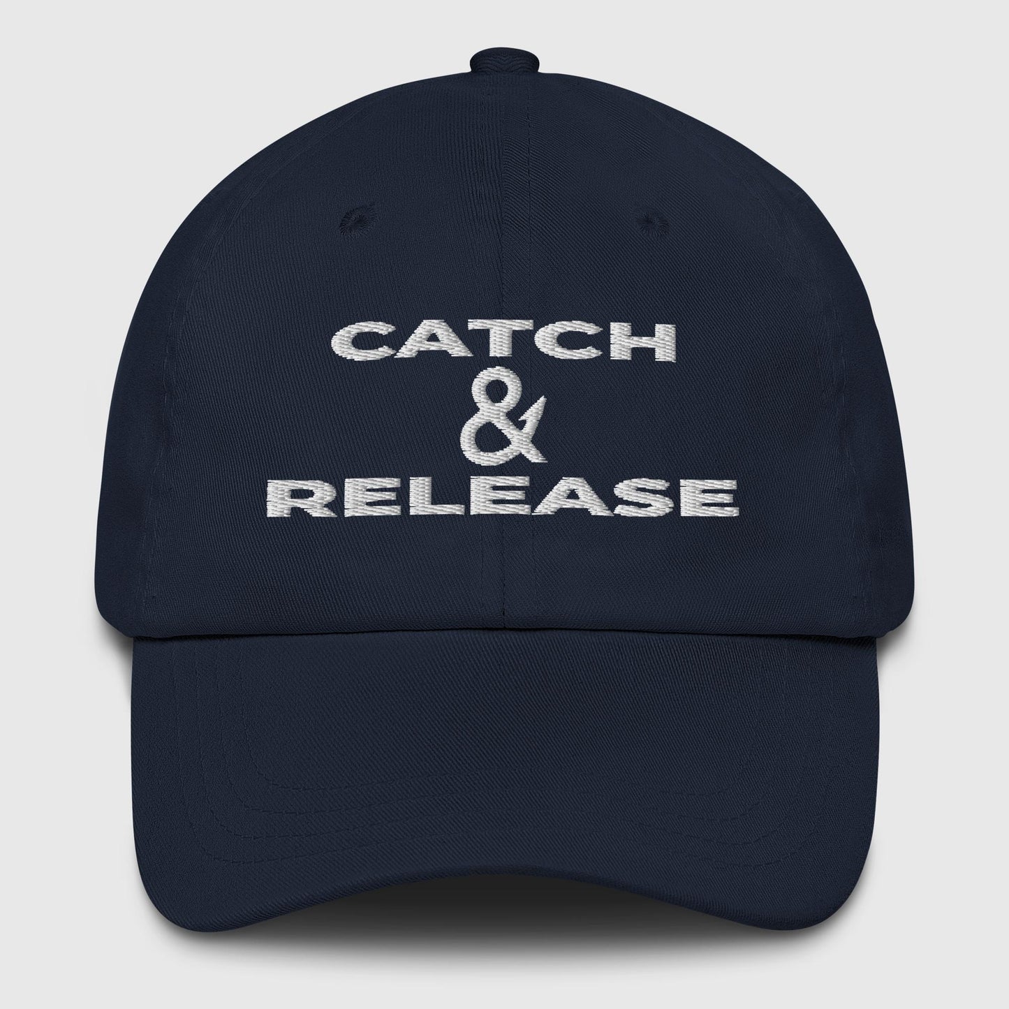 Navy dad hat with white Catch & Release lettering