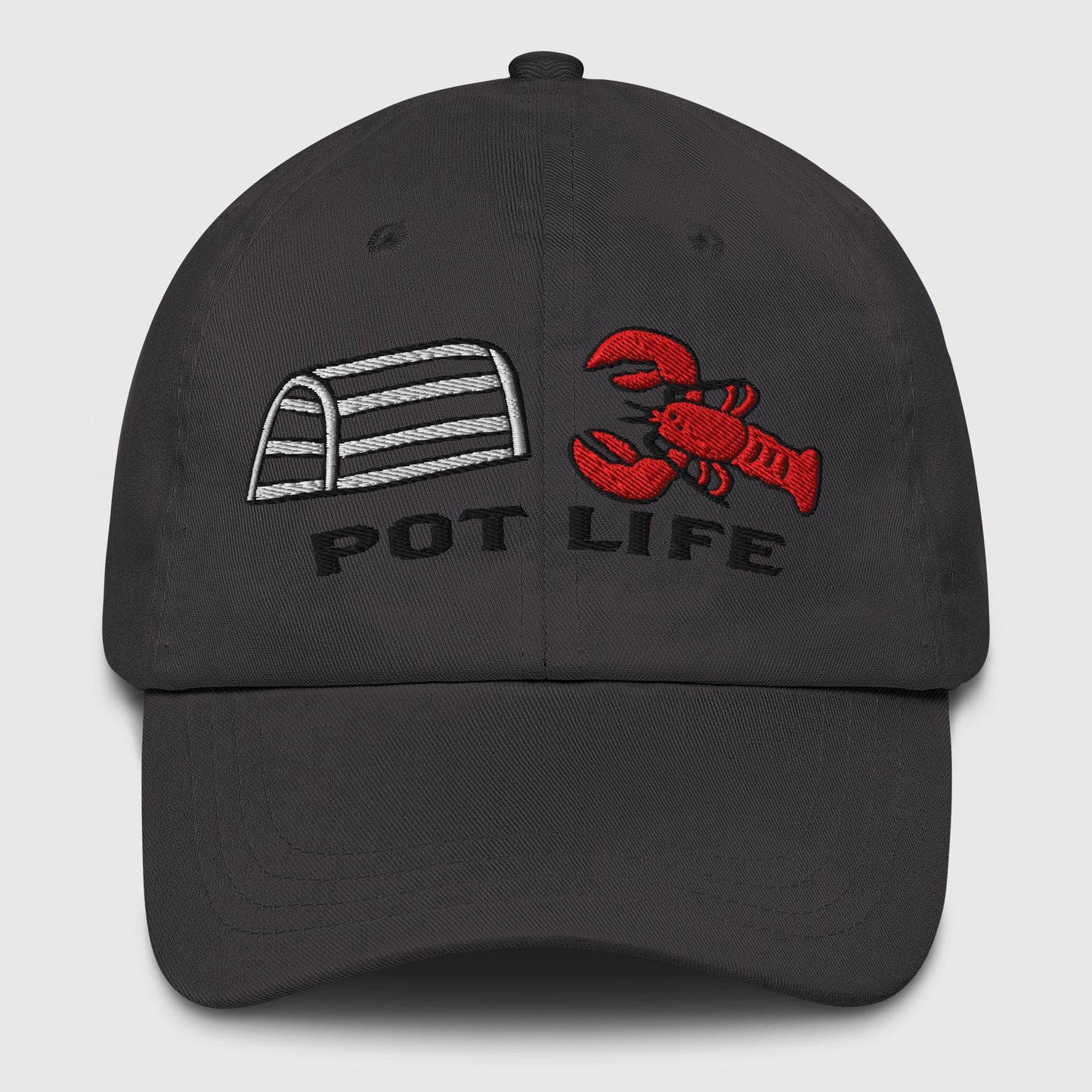 Dark grey dad hat with embroidered lobster trap, red lobster, and "POT LIFE" text on the front