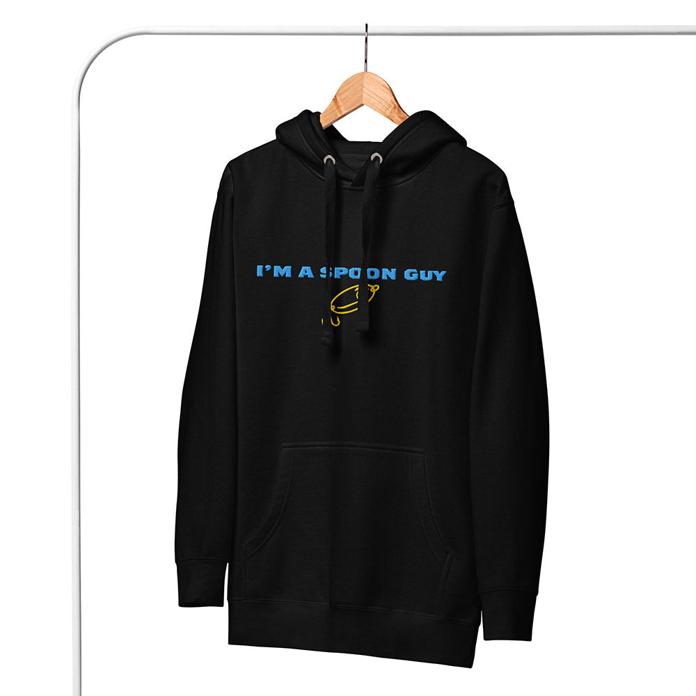 Black hoodie with "I’m a Spoon Guy" text and yellow fishing spoon graphic hanging on a wooden hanger