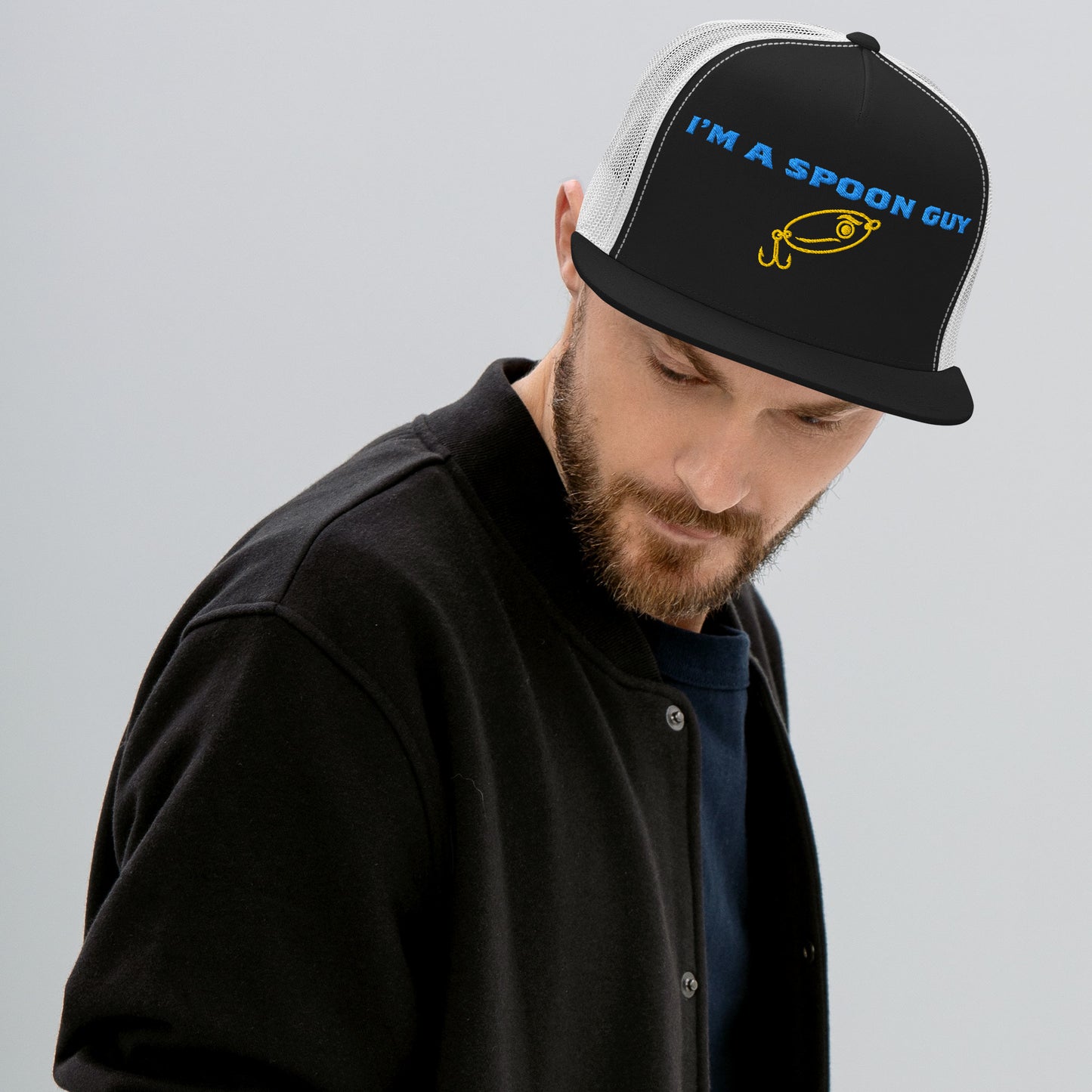 Man wearing a black and white trucker hat with "I'm a Spoon Guy" text and lure graphic