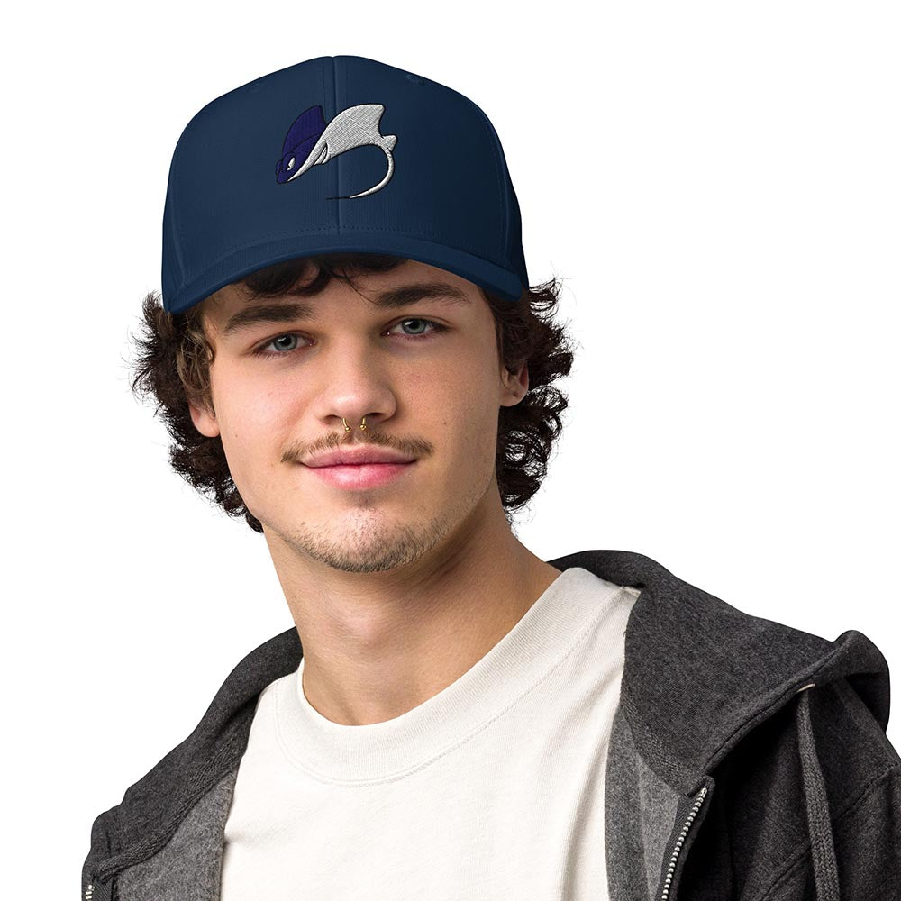 Man wearing a navy Adidas performance cap with stingray logo, front view