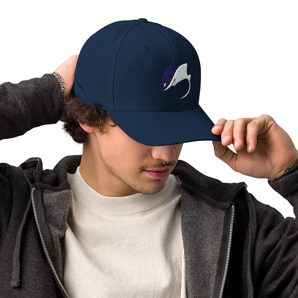 Man adjusting brim of a navy Adidas performance cap with stingray logo, three-quarter left view on white background