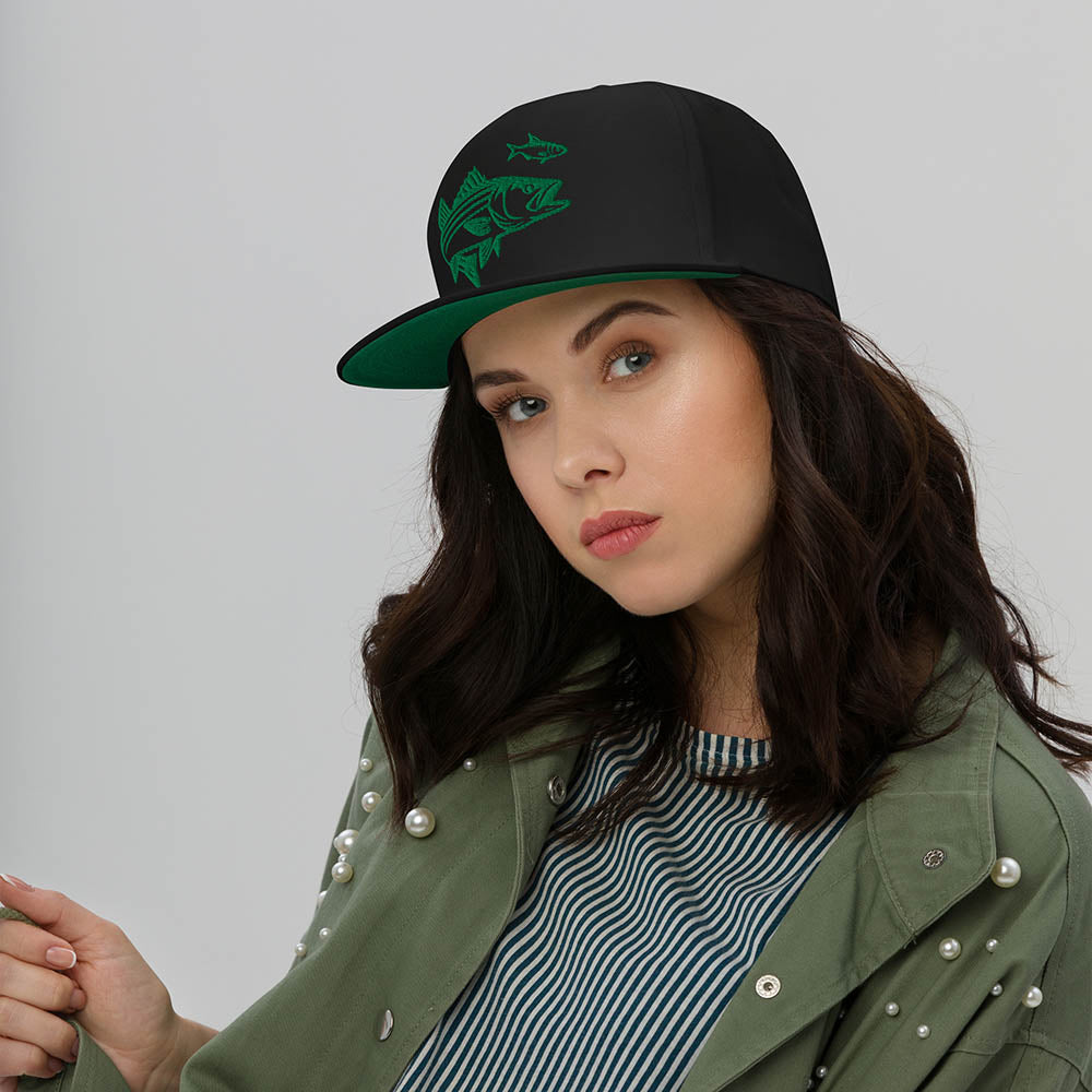 woman wearing black snapback hat with green striper fish embroidery