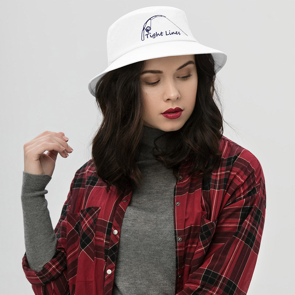 White bucket hat with embroidered 'Tight Lines' fishing rod and reel design, shown on female model front view