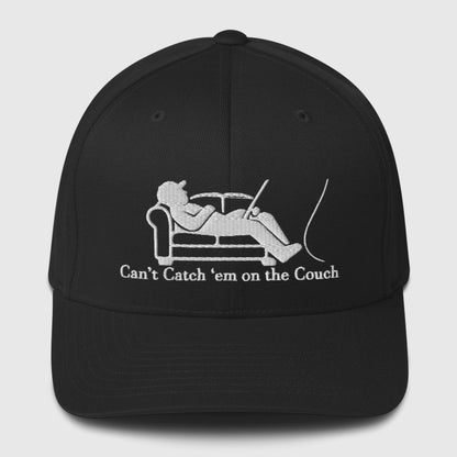Black structured ball cap with white graphic of person fishing on couch and text "Can't Catch 'em on the Couch" fishing hat. - Can't Catch 'Em Structured Ball Cap - Dark