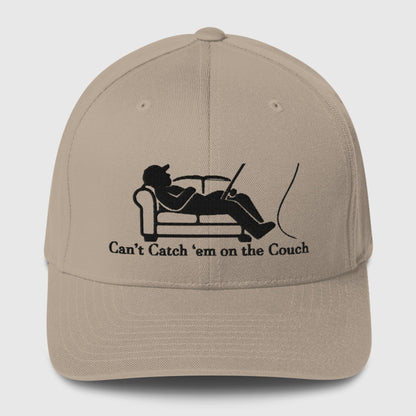 Khaki structured ball cap with black graphic of a fisherman lounging and text "Can't Catch 'Em on the Couch," funny fishing. - Can't Catch 'Em Structured Ball Cap - Light