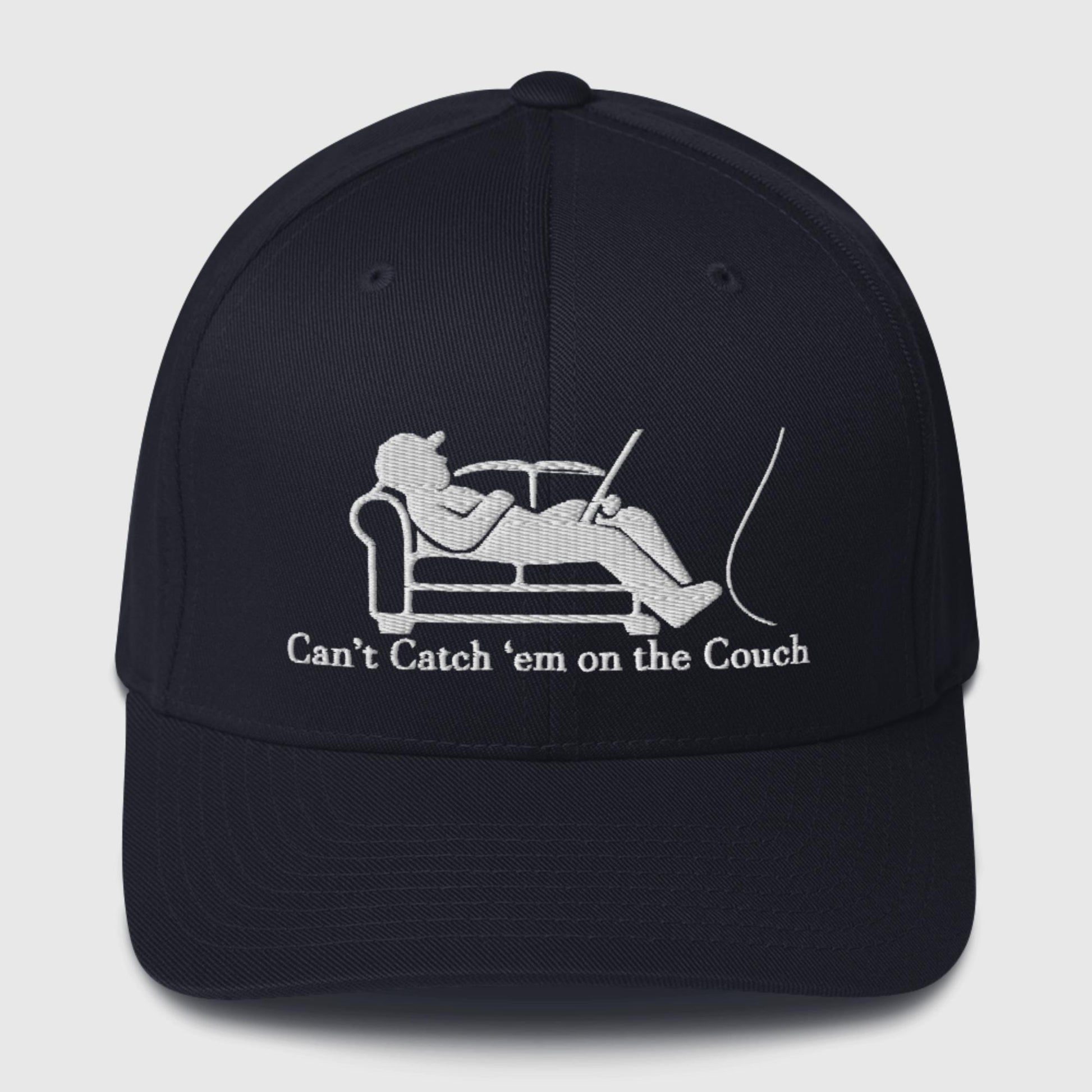 Navy dad hat with white couch and fisherman graphic, slogan underneath