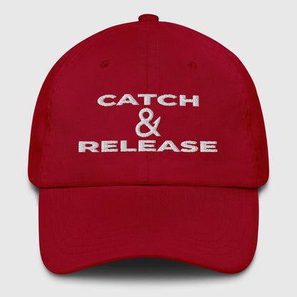 Red dad hat with white "Catch & Release" text, a funny fishing hat design. - Catch & Release Dad Hat