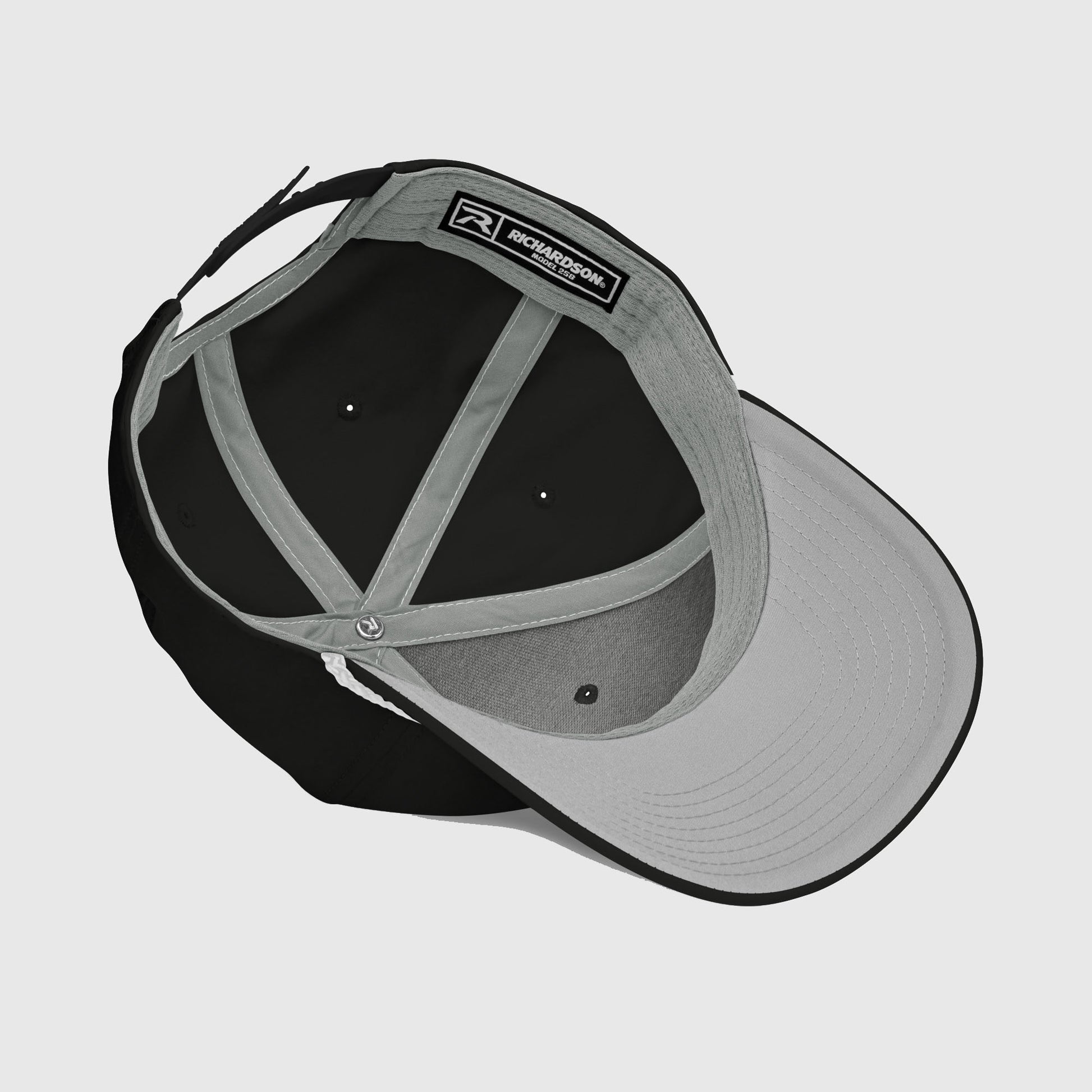 Inside view of black rope cap showing visor and stitching