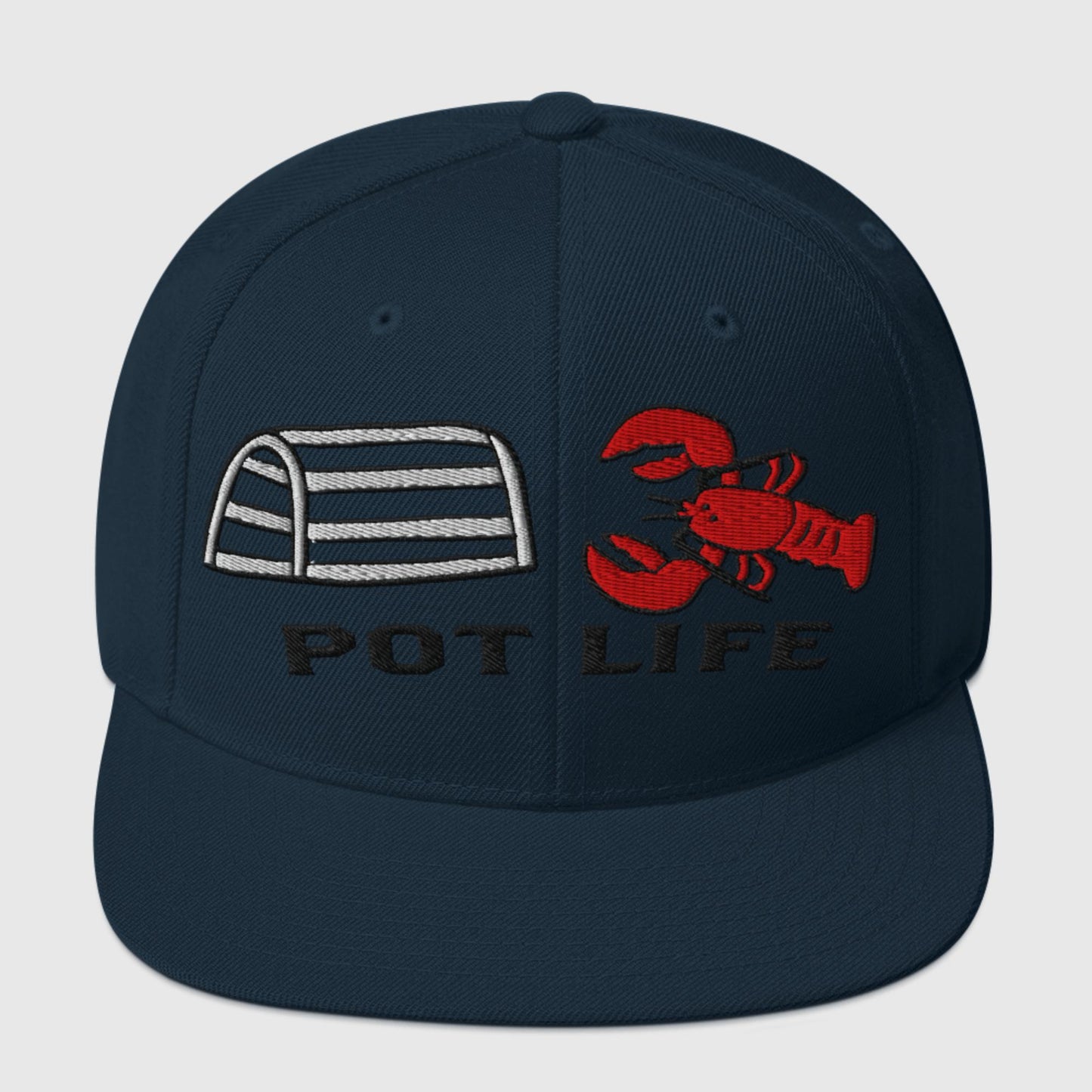 Dark navy snapback hat with embroidered lobster trap, red lobster, and “POT LIFE” text on the front