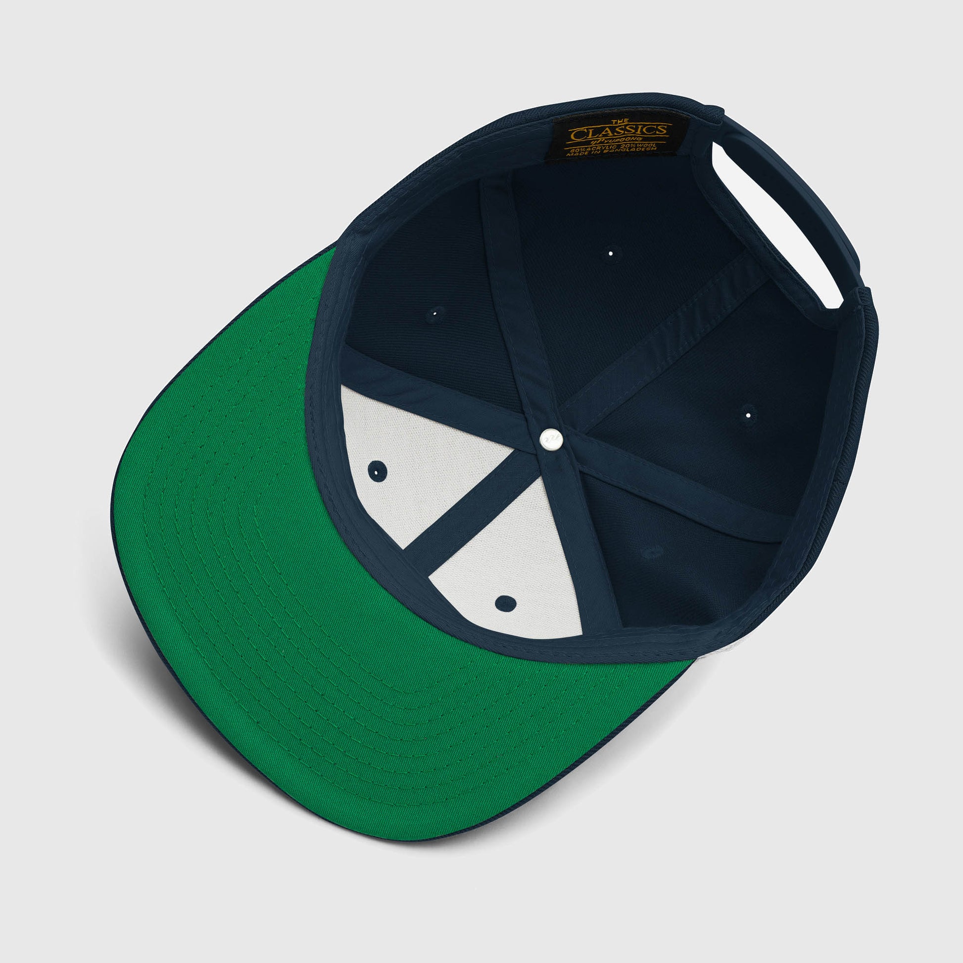 Inside view of dark navy snapback hat with green underbill and interior taping