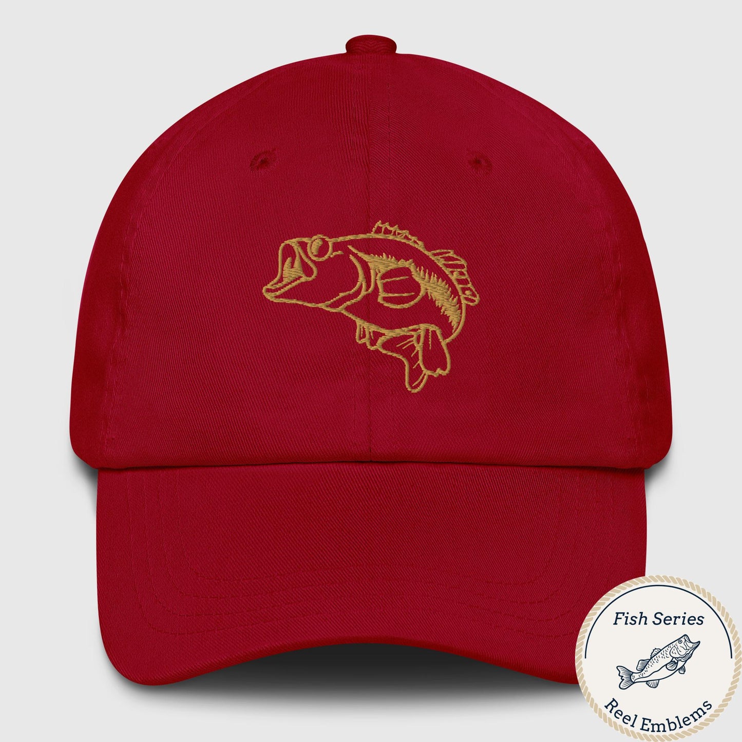 Red dad hat with embroidered largemouth bass design in gold thread, front view