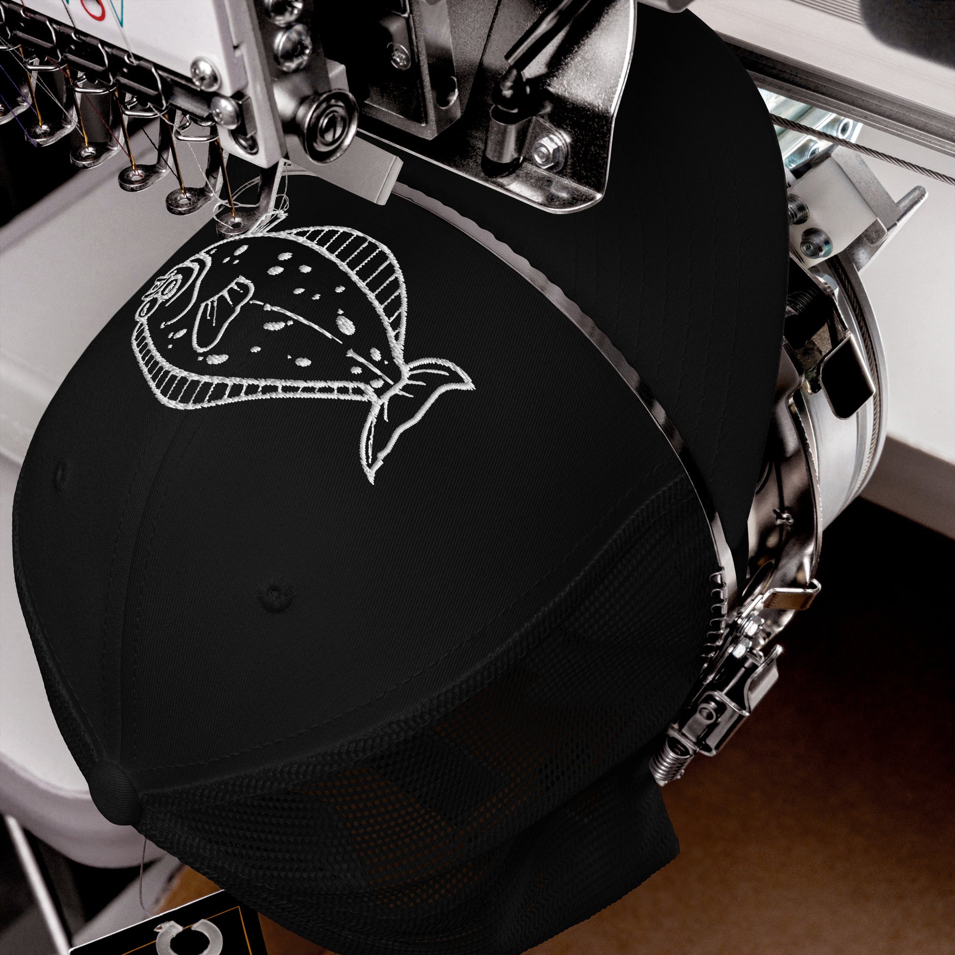 Close embroidery detail of halibut design on cap