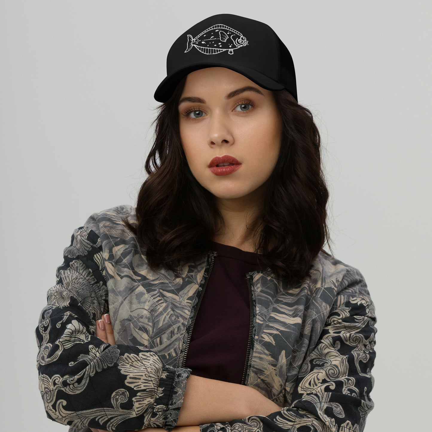 Woman styled in black halibut trucker cap