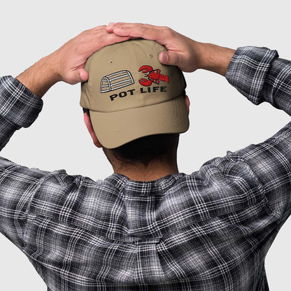 Khaki fishing hat with funny lobster graphic and "Pot Life" text, worn with plaid shirt. - Pot Life Lobster Dad Hat